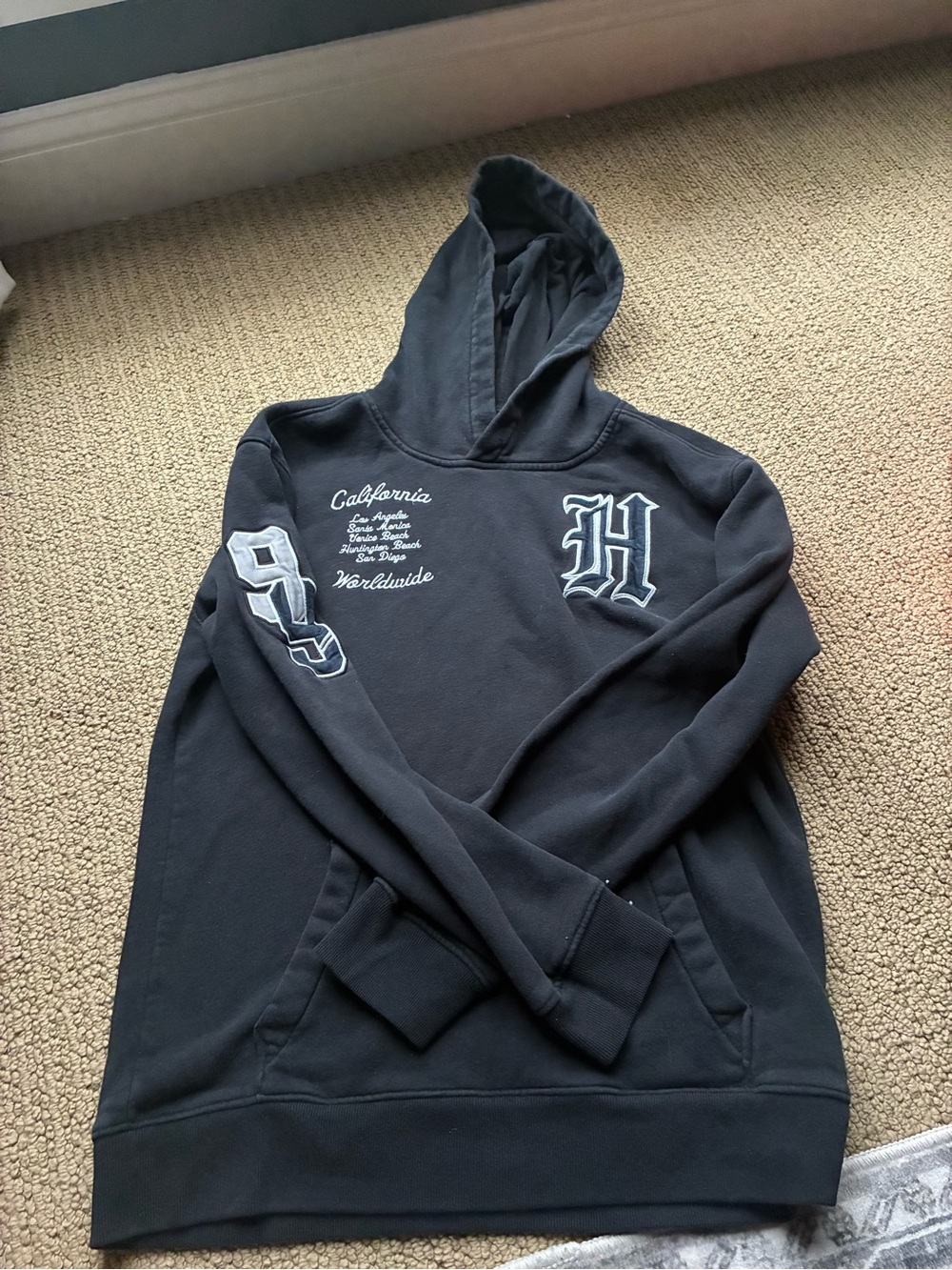 Hollister Men's Black Hooded Pullover Sweatshirt with Script and Patch Details
